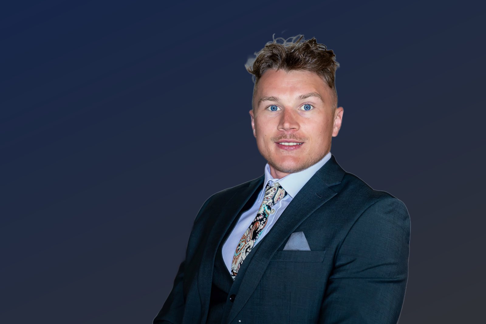 Rob Dalton seated in a navy suit