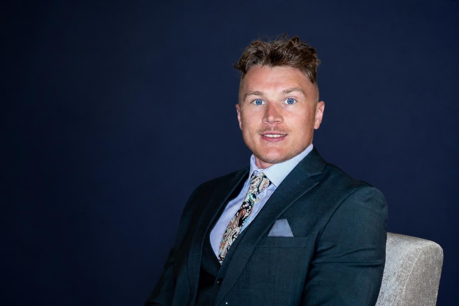 Rob Dalton, founder of Dalton Elite Solutions, seated in a navy suit